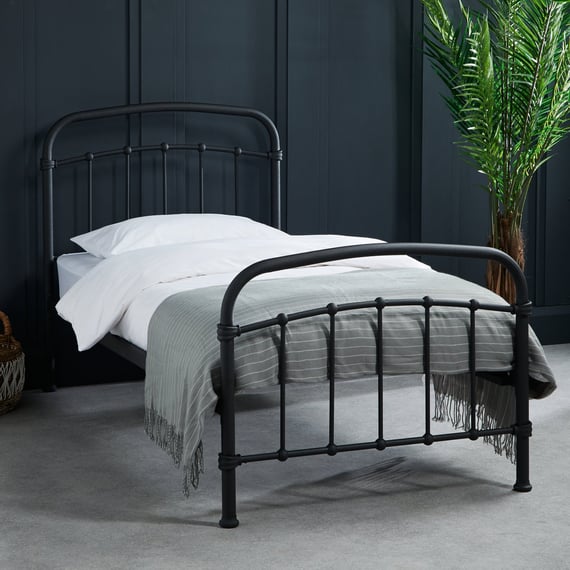 halston black single metal bed dark room shot