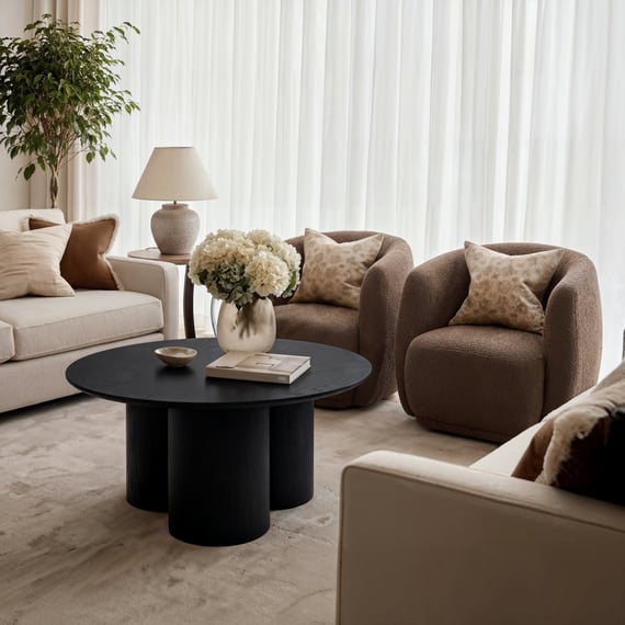 lane black round coffee table boucle chair scene